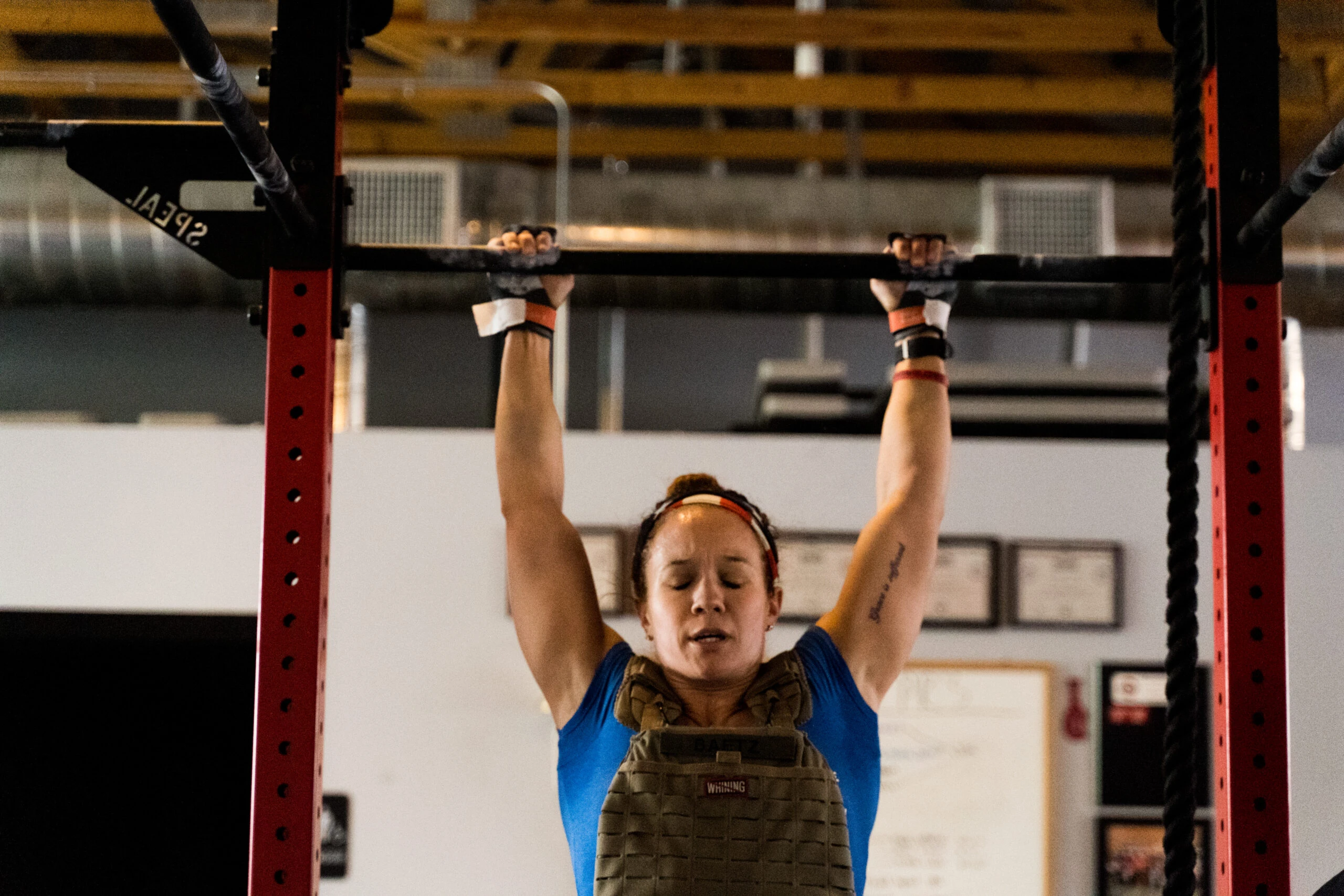 Woman doing a weighted pull up