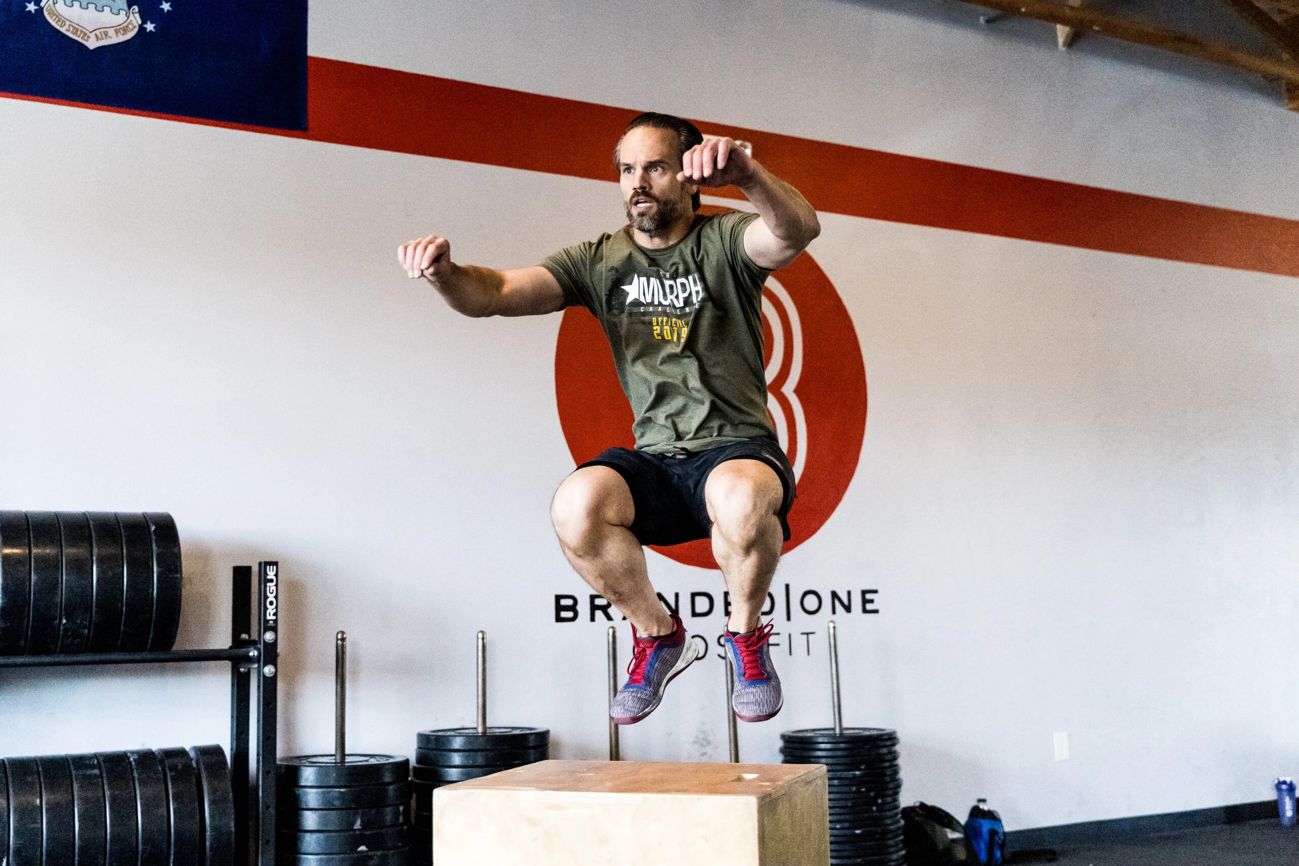 Man doing a box jump at a gym